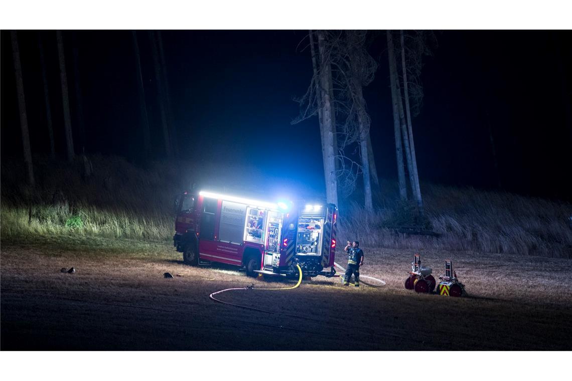 Die Feuerwehr überwacht am Waldrand Glutnester nach einem Waldbrand in einem Waldstück der Saalfelder Höhe.