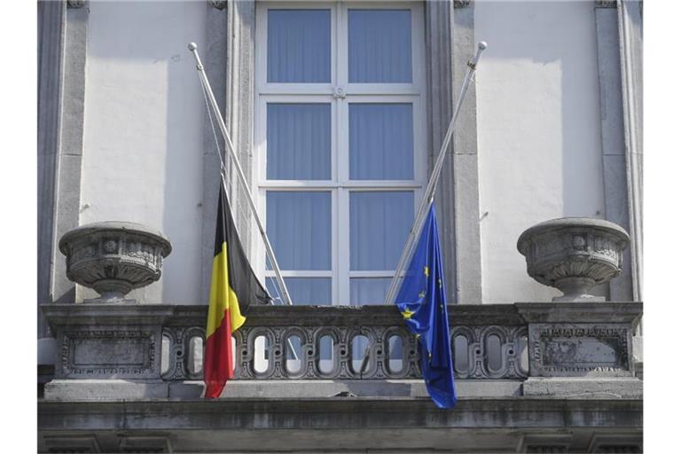 Die Flaggen vor dem förderalen Parlament hängen auf Halbmast. Belgien hält einen Staatstrauertag ab, um den Opfern der Hochwasserkatastrophe Respekt zu zollen. Foto: Laurie Dieffembacq/BELGA/dpa