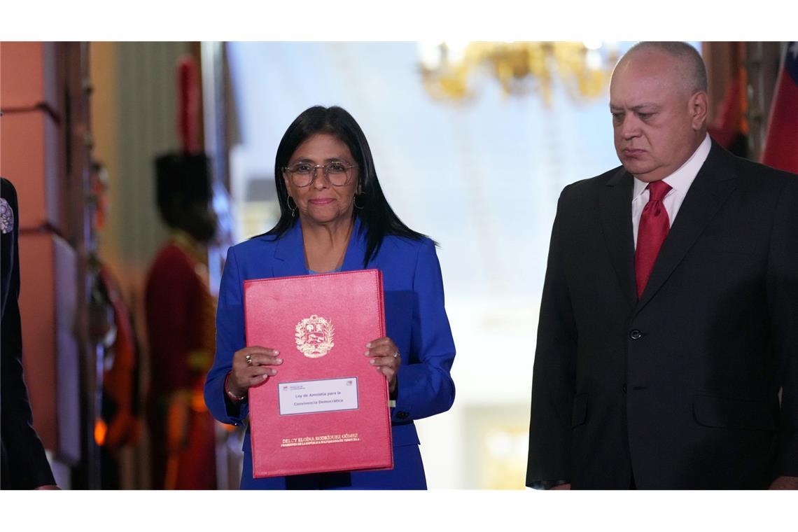 Die geschäftsführende Präsidentin Delcy Rodriguez hält ein verabschiedetes Amnestiegesetz hoch.
