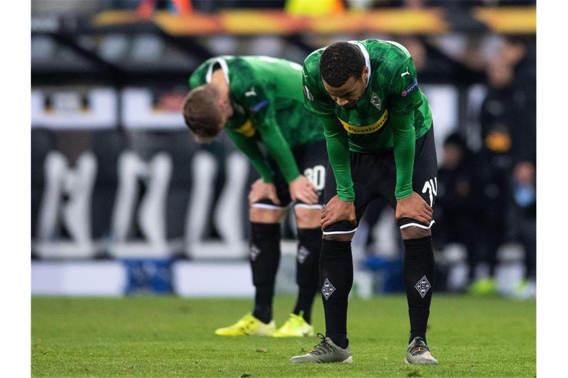 Die Gladbacher Nico Elvedi (l) und Alassane Plea können das Aus nicht fassen. Foto: Marius Becker/dpa