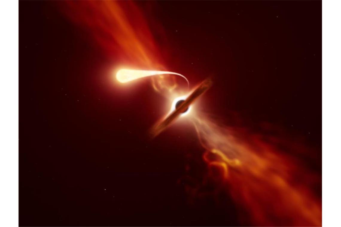 „Spaghettifizierung“: Schwarzes Loch frisst Stern Die grafische Darstellung zeigt einen Stern, während er von einem supermassiven Schwarzen Loch während eines „Gezeitenstörungsereignisses“ angesaugt wird. Foto: -/European Southern Observatory/dpa/Archivbild