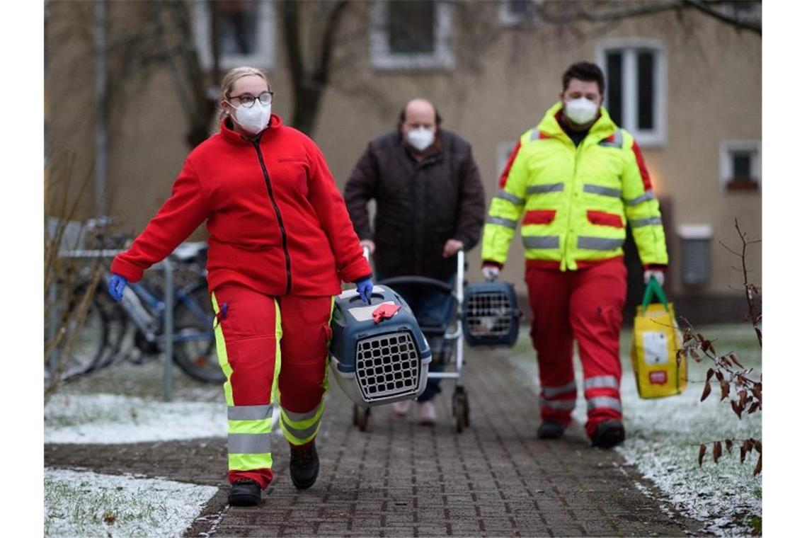 Die Katzen müssen natürlich auch mit: Diesem Anwohner mit einem Rollator wird geholfen seine Wohnung zu räumen. Foto: Swen Pförtner/dpa