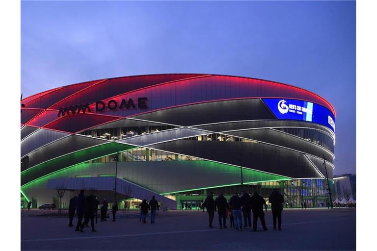 Die MVM Dome-Handball-Arena leuchtet vor dem Spiel in den Farben der ungarischen Flagge. Foto: Tamas Kovacs/MTI/AP/dpa