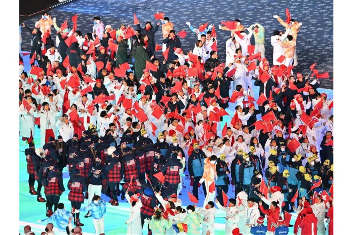 „Außergewöhnliche Spiele“: Olympia in Peking ist Geschichte Die olympischen Athleten winken zum Abschied der Winterspielen 2022. Foto: Peter Kneffel/dpa