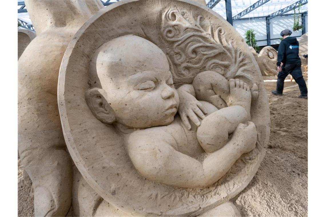 9000 Tonnen Sand in Form gebracht Die Sandskulptur eines Babys gehört zu Sandskulpturen-Schau auf Rügen. Foto: Stefan Sauer/dpa