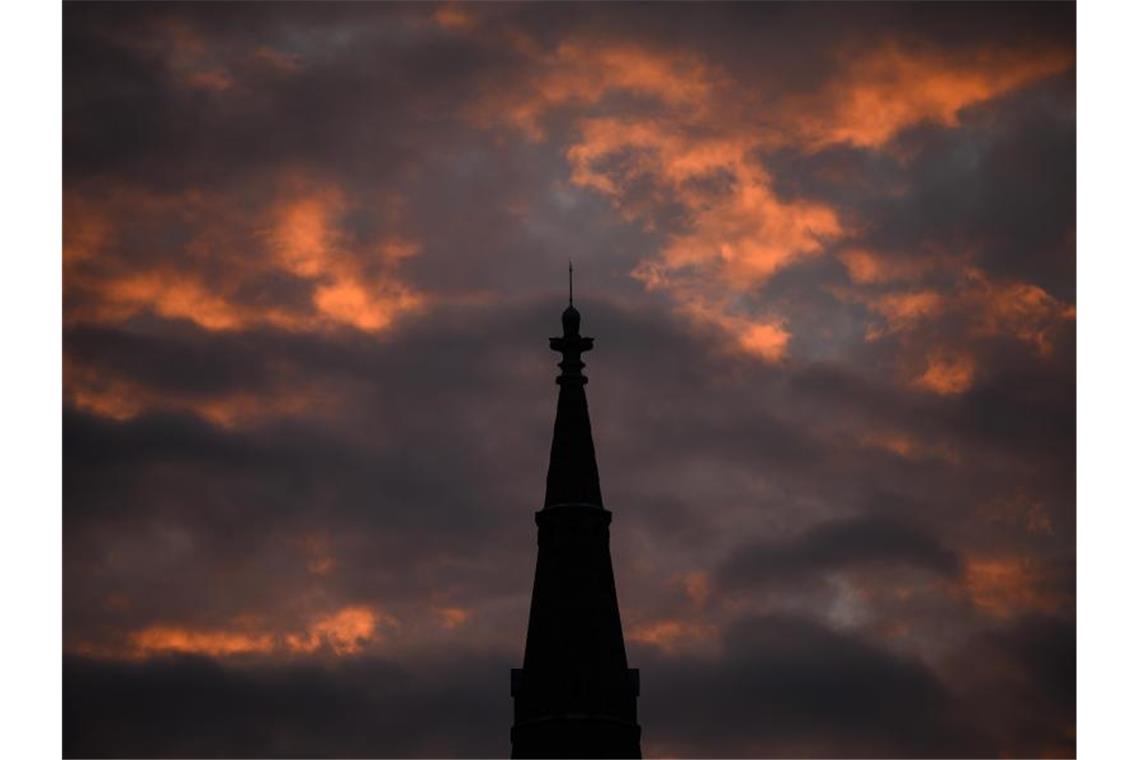 Die Sonne strahlt am Morgen die Wolken hinter der Matthäuskirche in Stuttgart an. Foto: Sebastian Gollnow/dpa/Archivbild