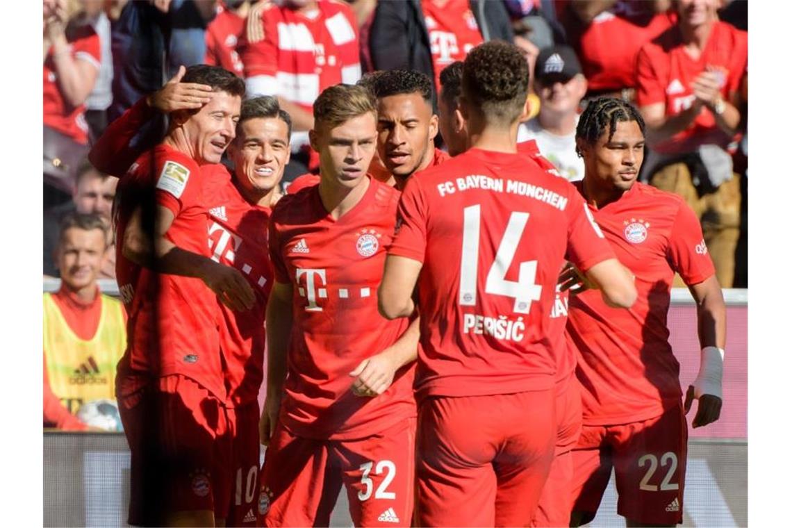 Die Spieler von Bayern München jubeln mit Torschütze Robert Lewandowski (l) über die 1:0-Führung gegen Union Berlin. Foto: Matthias Balk