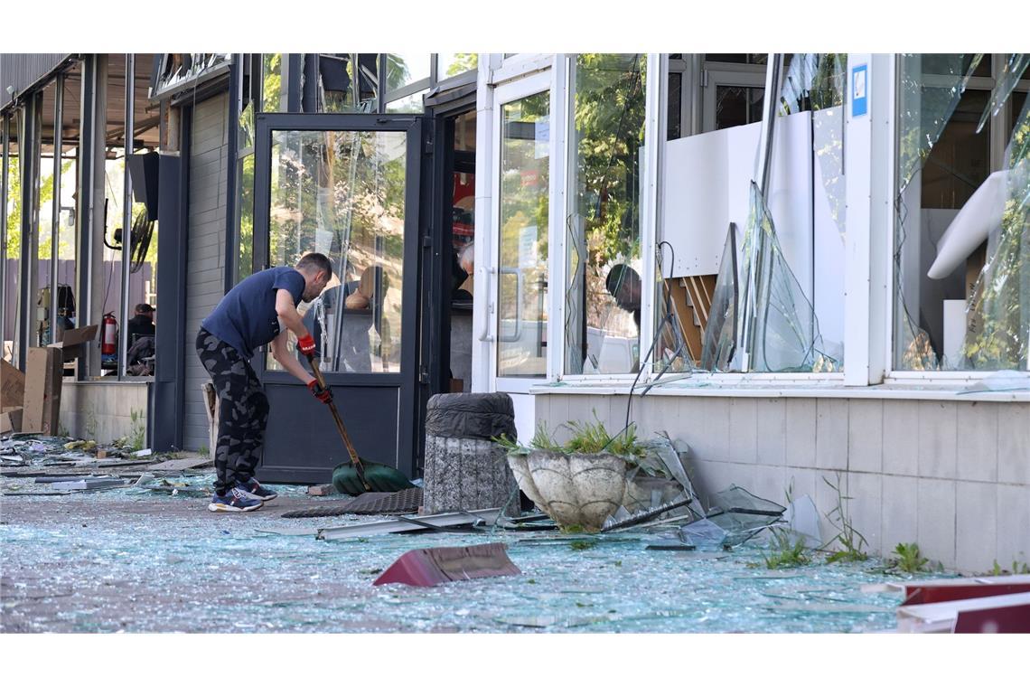 Die Spuren der Zerstörung beseitigen: Ein Mann kehrt in Odessa die Glasscherben eines Schaufensters zusammen, das bei einem russischen Raketenangriff zu Bruch gegangen ist.