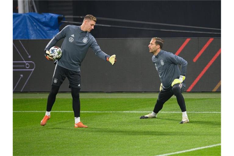 Die Torhüter Bernd Leno (l) und Oliver Baumann erwärmen sich. Foto: Robert Michael/dpa-Zentralbild/dpa/Aktuell