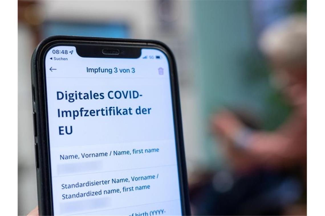 Südwest-Einzelhändler begrüßen Wegfall der 3G-Regel "Digitales Covid-Impfzertifikat der EU" steht auf einem Handy in einem Friseursalon. Foto: Armin Weigel/dpa/Symbolbild
