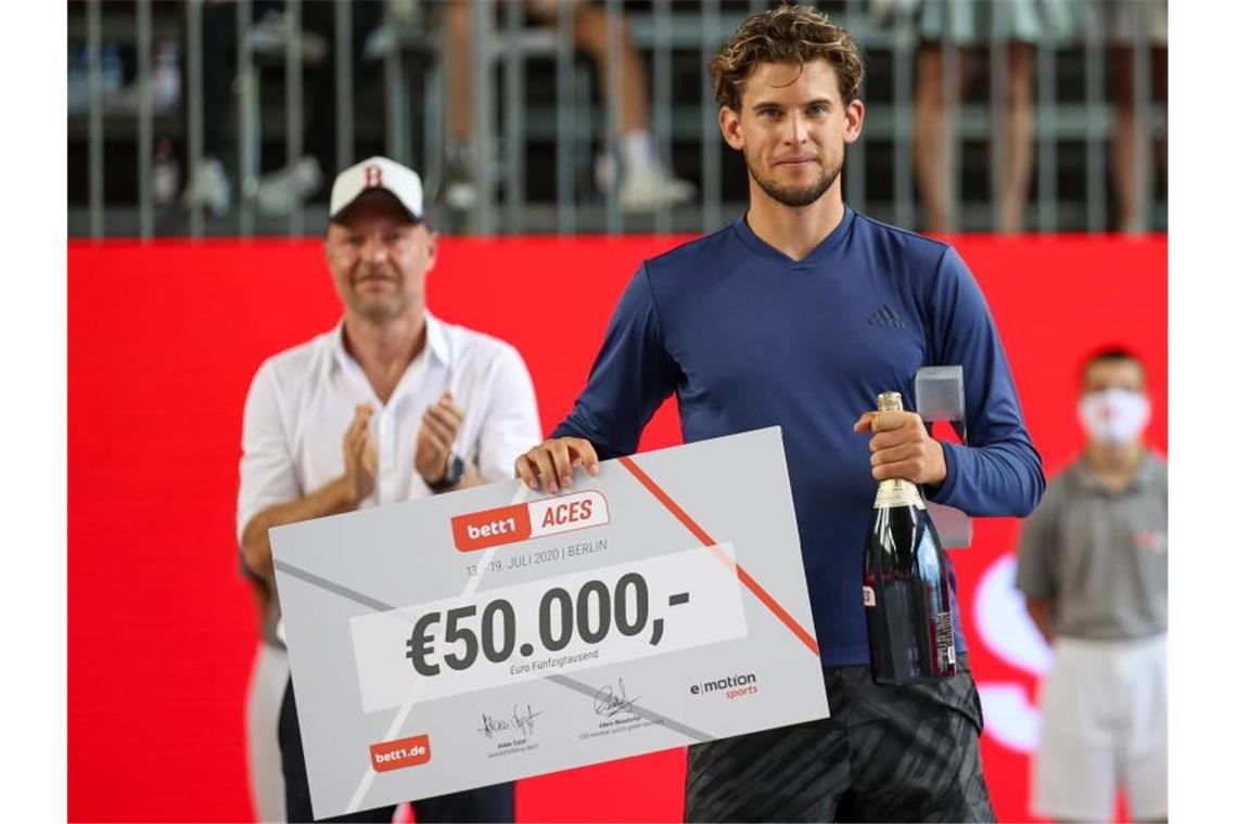 Dominic Thiem mit dem 50.000-Euro-Siegerscheck. Foto: Andreas Gora/dpa