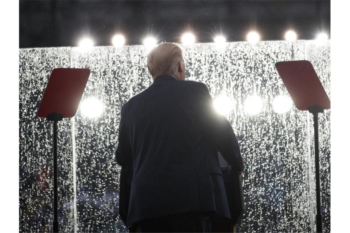 Trump mit Militärschau zum Unabhängigkeitstag Donald Trump hält bei Regen seine Rede hinter einem Sicherheitsglas. Foto: Carolyn Kaster/AP