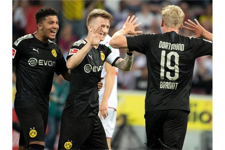 Dortmunds Jadon Sancho (l-r), Marco Reus und Julian Brandt feiern das Tor zum 2:1. Foto: Federico Gambarini
