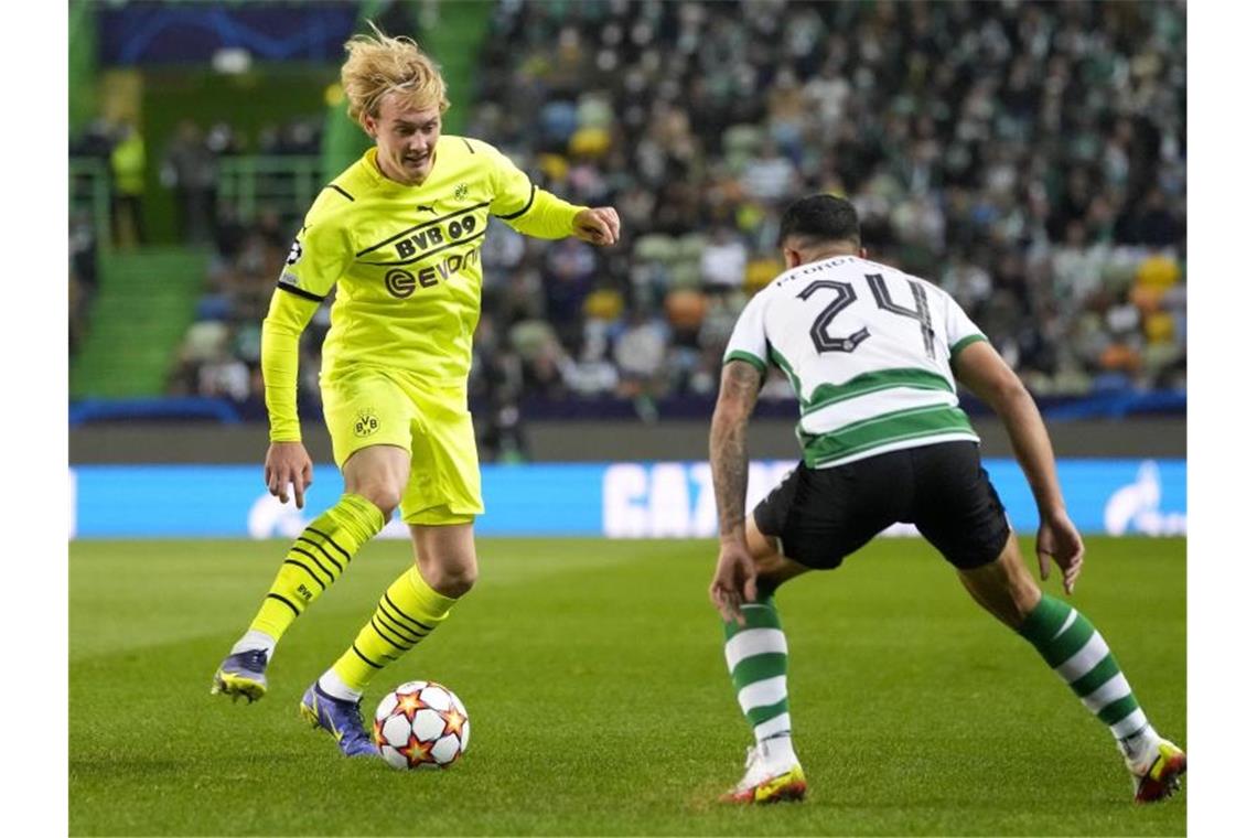 Champions-League-K.o. für desolaten BVB in Lissabon Dortmunds Julian Brandt fintiert, um an Sportings Pedro Porro (r) vorbeizukommen. Foto: Armando Franca/AP/dpa