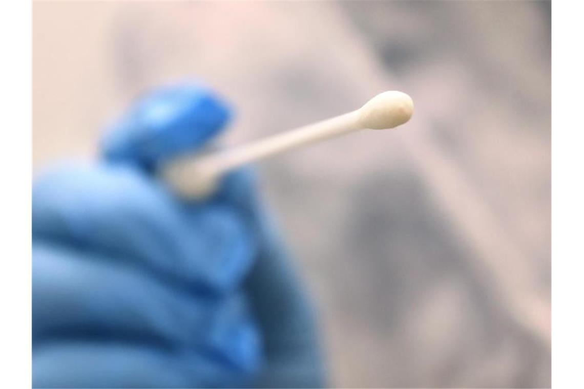 Ein Arzt hält einen Tupfer zum Abstrich für einen Corona-Test in der Hand. Foto: Karl-Josef Hildenbrand/dpa/Symbolbild