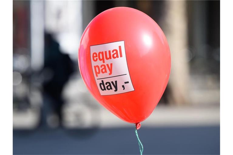 Ein Ballon mit Aufschrift „Equal Pay Day“ fliegt in der Luft. Foto: Julian Stratenschulte/dpa/Symbolbild
