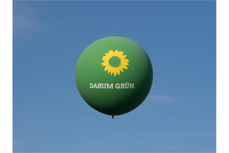 Ein Ballon mit der Aufschrift „Darum Grün“ schwebt über einer Wahlkampfveranstaltung über dem Stuttgarter Schlossplatz. Foto: Marijan Murat