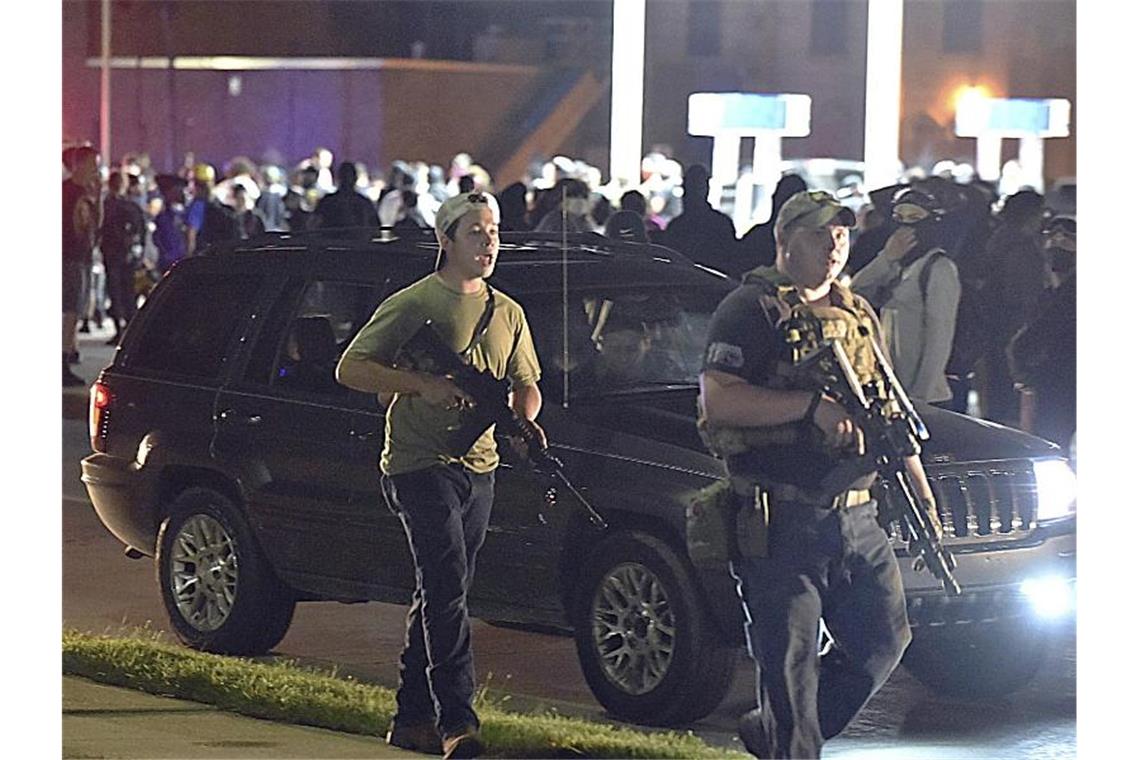 Ein bewaffneter 17-Jähriger (l) während eines Protestes gegen Rassismus und Polizeigewalt. Der 17-Jährige soll die tödlichen Schüsse bei Protesten in der US-Stadt Kenosha abgefeuert haben. Foto: Adam Rogan/The Journal Times/AP/dpa