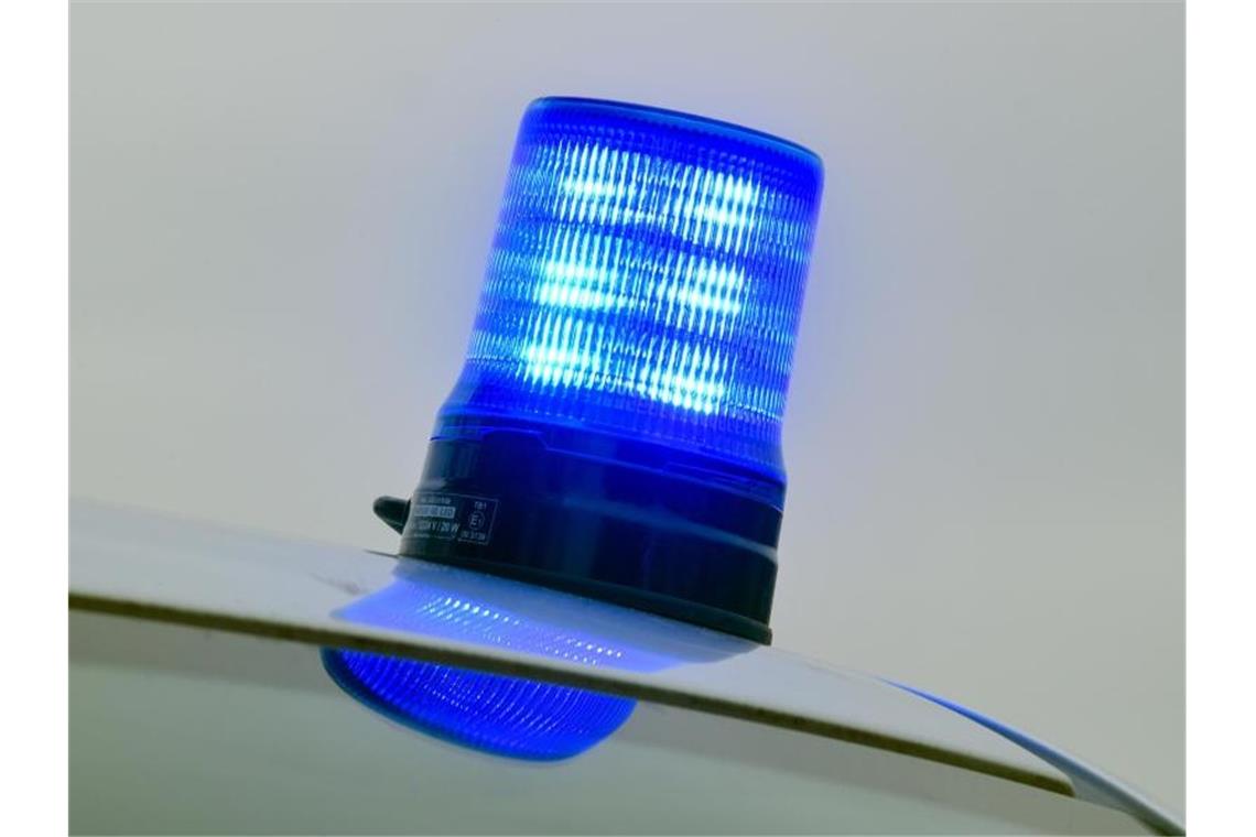 Ein Blaulicht ist auf dem Dach eines Polizeiautos angebracht und leuchtet. Foto: Patrick Pleul/Archivbild