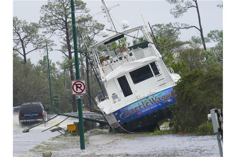 Ein Boot ist durch den Hurrikan „Sally“ an Land gewirbelt worden und liegt nun neben einer Straße. Foto: Gerald Herbert/AP/dpa
