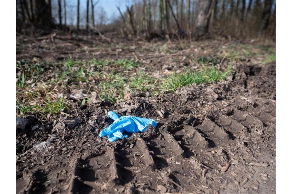 Ein Einmalhandschuh liegt nahe des mutmaßlichen Tatorts. Foto: Sebastian Gollnow/dpa