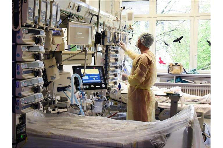 Ein Fachkrankenpfleger auf einer Intensivstation, auf der an Covid-19 erkrankte Patienten behandelt werden. Foto: Waltraud Grubitzsch/dpa/Symbolbild