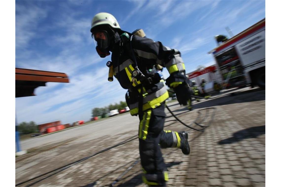 Ein Feuerwehrmann in Atemschutz während einer Einsatz-Übung am Flughafen München. Foto: picture alliance / Stephan Jansen/dpa