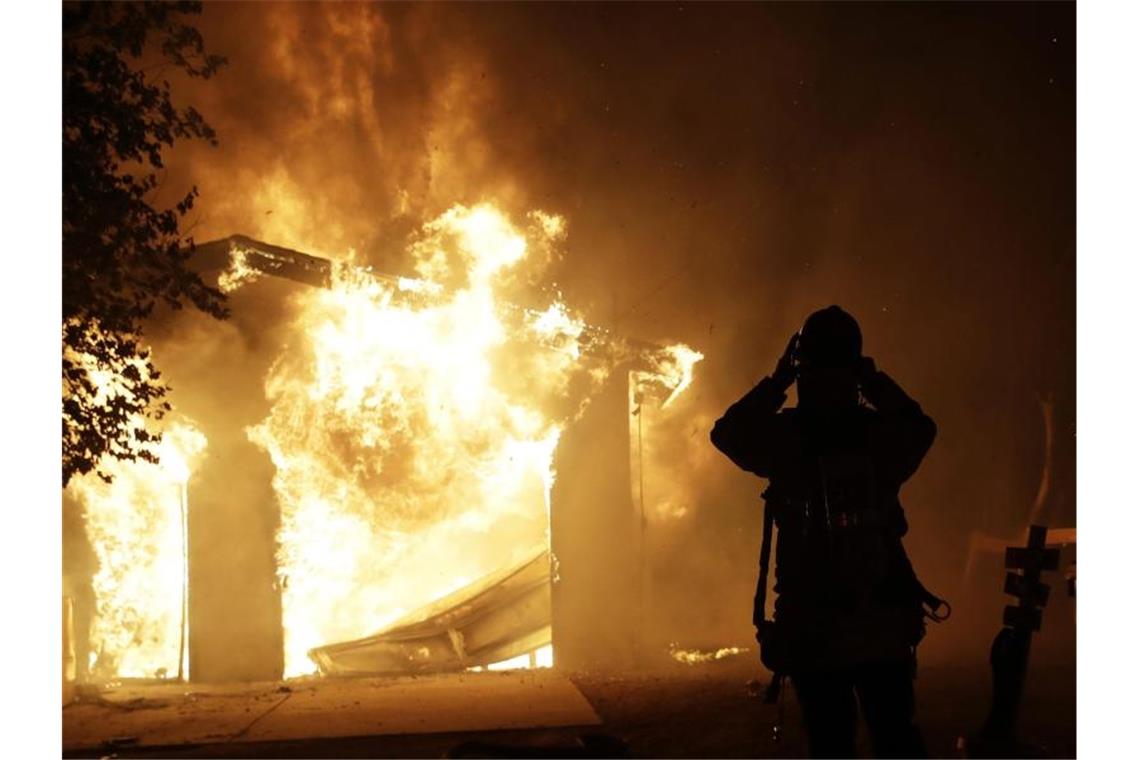 Zehntausende fliehen vor Waldbränden in Kalifornien Ein Feuerwehrmann vor einem brennenden Haus im kalifornischen Santa Clarita. Foto: Marcio Jose Sanchez/AP/dpa