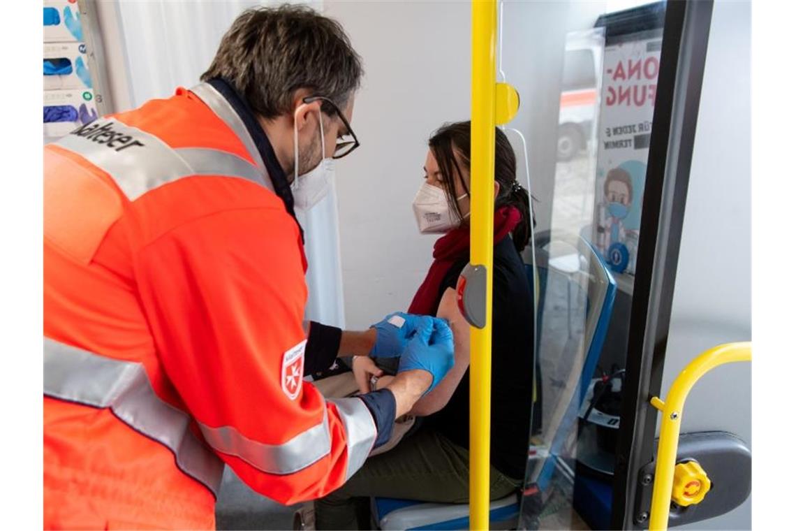 Ein Frau erhält in einem Impfbus in München ihre Booster-Impfung. Foto: Sven Hoppe/dpa