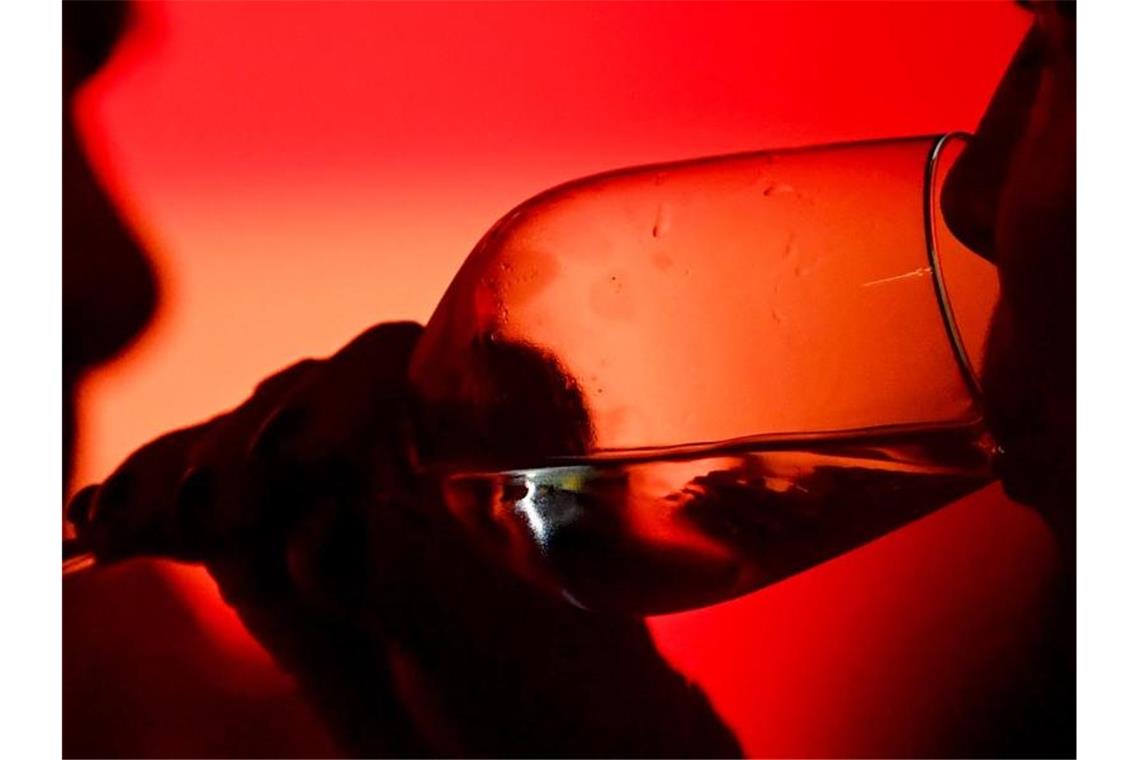 Nach Corona-Absage wird „wirtuelles Weindorf“ aufgebaut Ein Gast trinkt aus einem Weinglas. Foto: Jens Kalaene/dpa-Zentralbild/ZB/Symbolbild