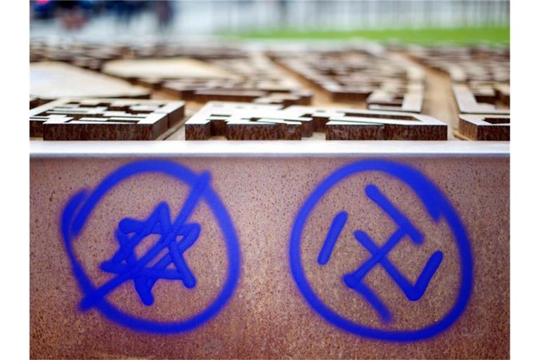 Ein Hakenkreuz und ein durchgestrichener Davidstern sind an einer Gedenkstätte zu sehen. Foto: Daniel Reinhardt/dpa