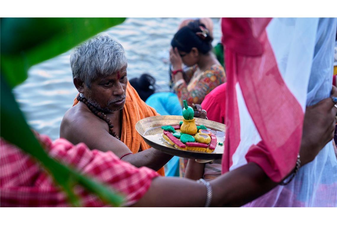 Ein Hindu-Priester führt am ersten Tag des Durga-Puja-Festes am Ufer des Hooghly-Flusses in Kolkata ein Rituale durch.