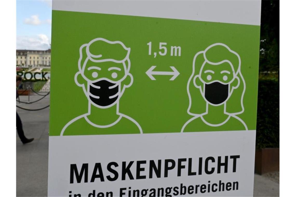 Ein Hinweisschild fordert zum Tragen von Schutzmasken gegen das Coronavirus auf. Foto: Bernd Weißbrod/dpa