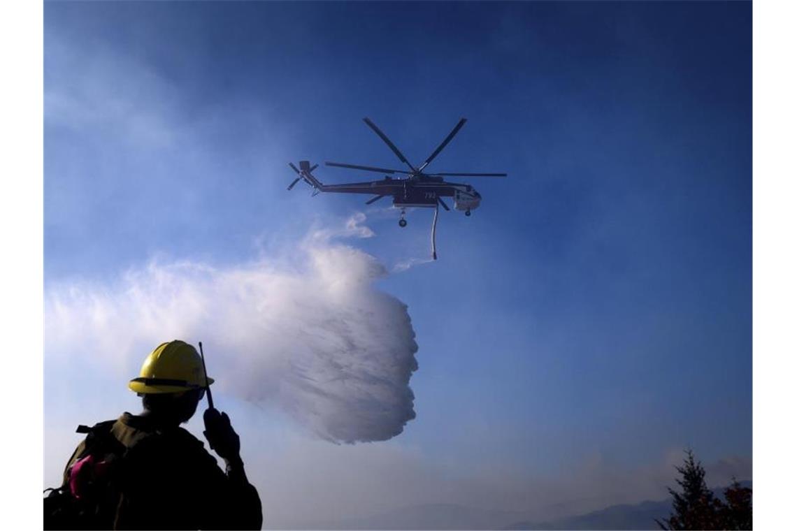 Ein Hubschrauber ist bei einem Waldbrand im Einsatz. Foto: Noah Berger/AP/dpa