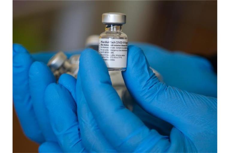 Ein Impfarzt hält einen Behälter mit dem Impfstoff gegen Covid-19 von Pfizer in einem Impfzentrum während der Impfung. (Archivbild). Foto: Dinendra Haria/SOPA Images via ZUMA Press Wire/dpa