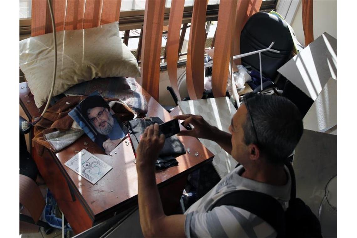 Ein Journalist macht Fotos von den Schäden in einem Medienbüro der Hisbollah-Miliz, wo eine israelische Drohne abgestürzt ist. Foto: Bilal Hussein/AP