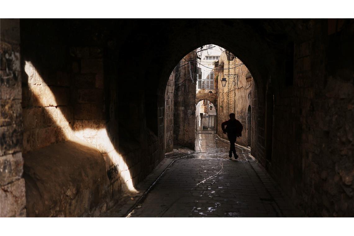 Ein Jugendlicher geht durch eine Gasse in der Altstadt von Aleppo.