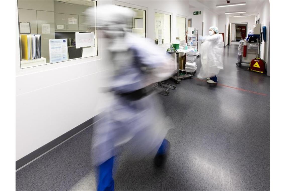 Ein Krankenpfleger läuft über den Flur einer Intensivstation. Foto: Frank Molter/dpa