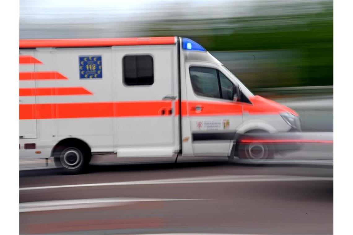 Ein Krankenwagen fährt mit Blaulicht über eine Sraße. Foto: Hendrik Schmidt/Archivbild