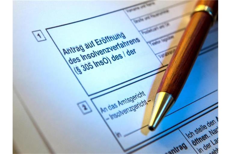 Ein Kugelschreiber liegt auf einem Antrag zur Eröffnung eines Insolvenzverfahrens. Foto: picture alliance/Alexander Heinl/dpa/Symbolbild