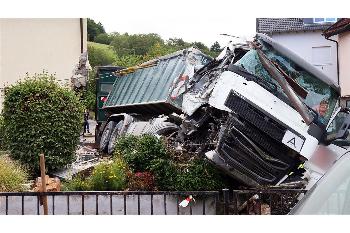Ein Lkw kracht in ein Wohnhaus und kippt um.