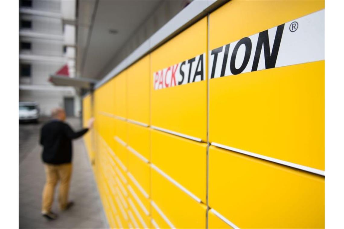 Ein Mann an einer DHL-Packstation. Die Paketgeschäfte der Deutschen Post wachsen weiter. Foto: Lino Mirgeler/dpa