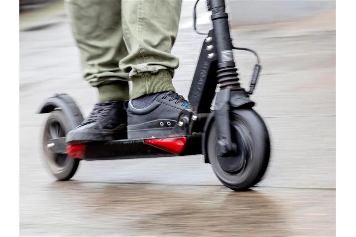 Ein Mann fährt mit einem E-Scooter auf dem Gehweg. Foto: Christoph Soeder
