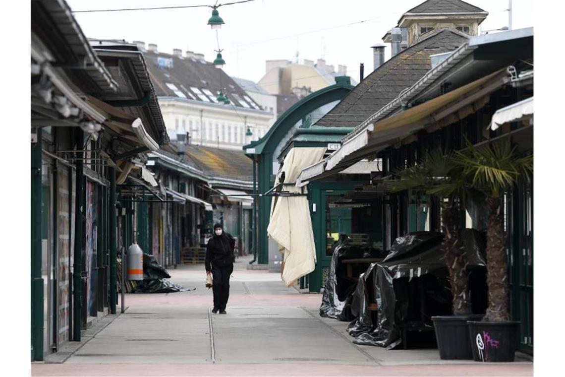 Der Osten Österreichs geht in einen Oster-Lockdown Ein Mann läuft am geschlossenen Wiener Naschmarkt entlang. Im Osten Österreichs werden rund um Ostern die Corona-Maßnahmen verschärft. Foto: Helmut Fohringer/APA/dpa