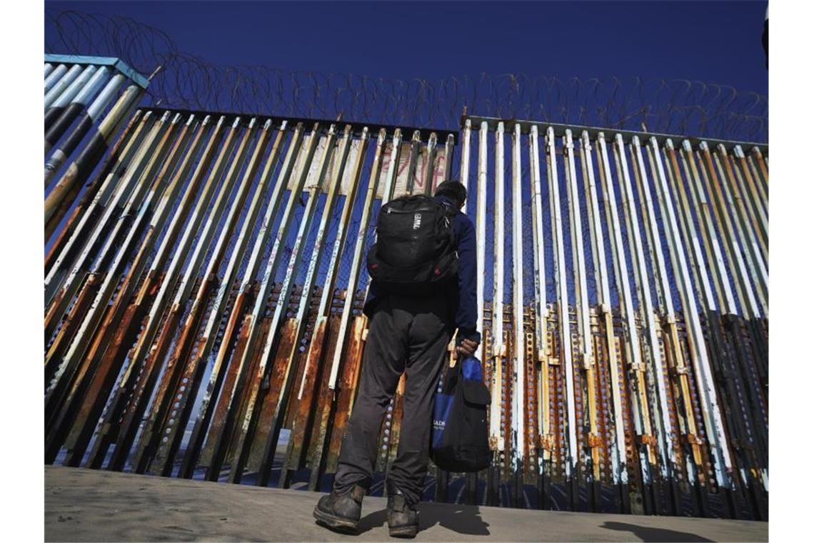 Polizei in Texas befreit 132 Migranten aus Lastwagen Ein Mann steht an der US-mexikanischen Grenze in Tijuana. Foto: Marco Ugarte/AP/dpa