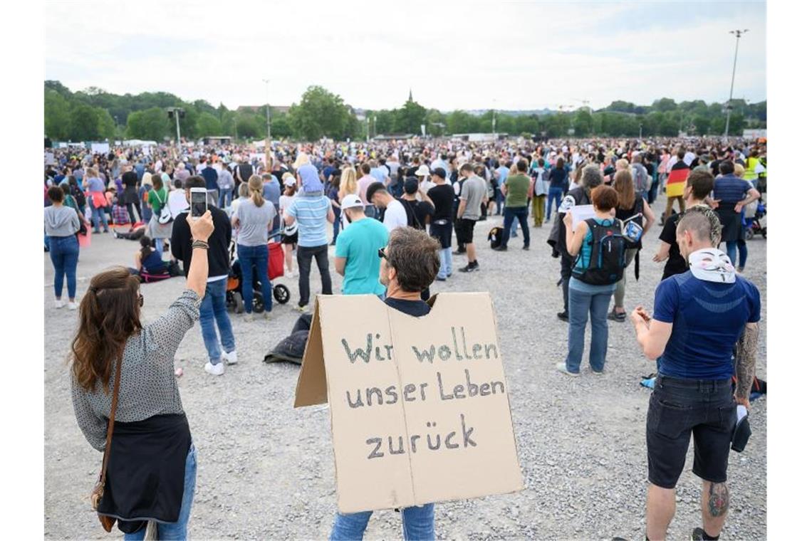 Erneut Tausende bei Demo gegen Corona-Regeln in Stuttgart Ein Mann steht während einer Protestkundgebung der Initiative „Querdenken 711“ auf dem Cannstatter Wasen. Foto: Sebastian Gollnow/dpa/Archivibild