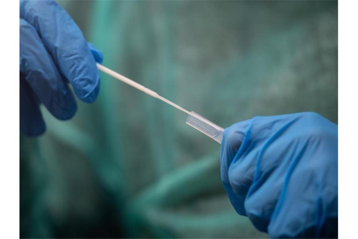 Corona-Inzidenz im Südwesten geht leicht nach oben Ein Mitarbeiter hält ein Abstrichstäbchen für die Durchführung eines Corona-Tests in der Hand. Foto: Sebastian Gollnow/dpa/Symbolbild