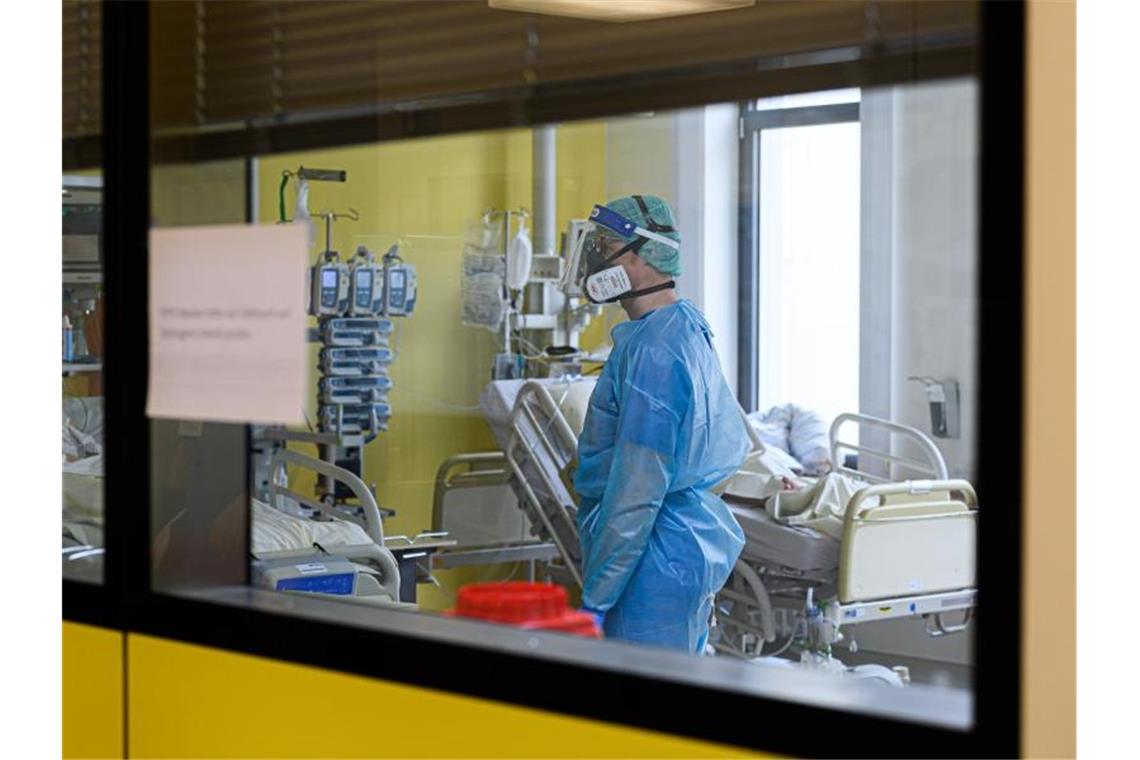 Pandemie: Südwesten hofft auf Fachkräfte aus dem Ruhestand Ein Pfleger versorgt auf einer Covid-19-Intensivstation Corona-Patienten. Foto: Robert Michael/dpa-Zentralbild/dpa/Symbolbild