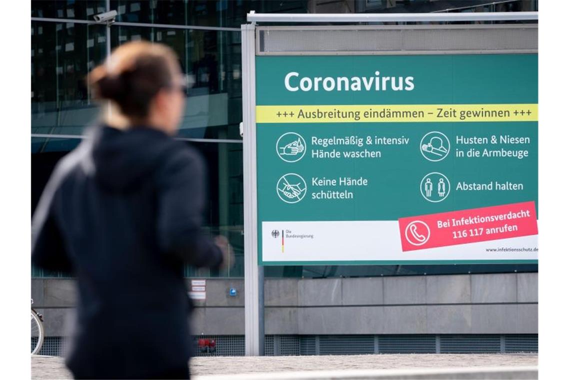 Ein Plakat informiert vor dem Bundespresseamt über Schutzmaßnahmen zum Coronavirus. Foto: Kay Nietfeld/dpa