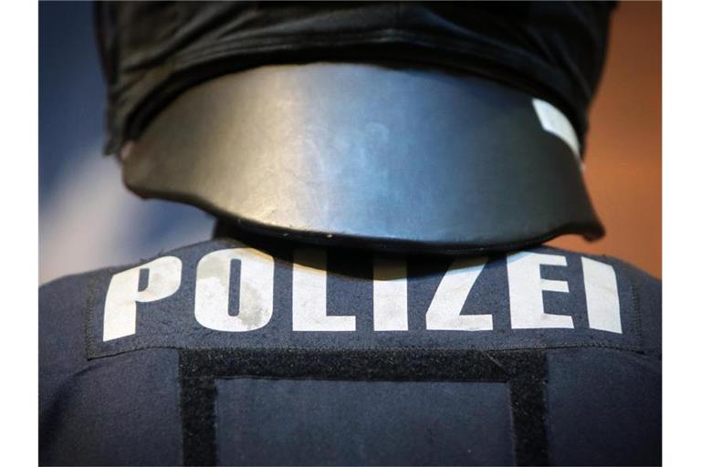 Ein Polizeibeamter in Schutzkleidung. Foto: Fredrik von Erichsen/dpa/Archivbild